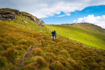 Hiker taking photos in the Carpathian Mountains, Romania