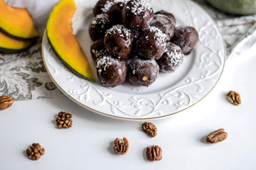 tasty homemade pumpkin candy balls in dark chocolate topping of coconut crumbs