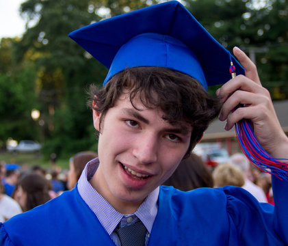 High School Graduate Teenager In Blue Graduation Gown