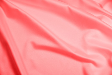 Closeup of rippled coral satin fabric