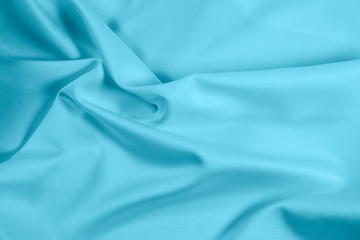 Closeup of rippled light blue satin fabric