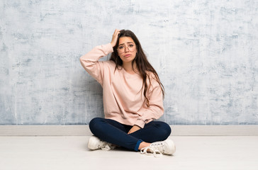 Teenager student girl studying in a table with an expression of frustration and not understanding