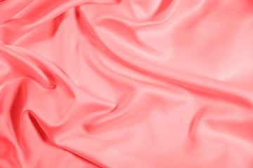 Closeup of rippled coral satin fabric