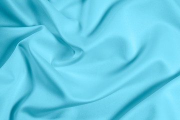 Closeup of rippled light blue satin fabric