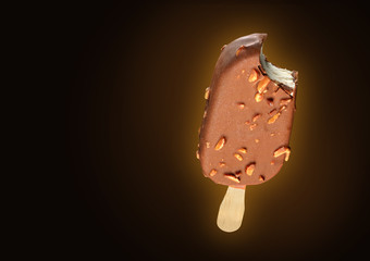 Chocolate popsicle with nuts on black
