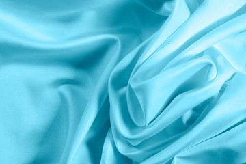 Closeup of rippled light blue satin fabric