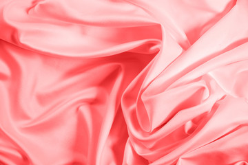 Closeup of rippled coral satin fabric