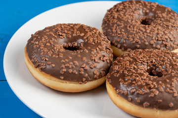 Donut With Chocolate Topping Cream On The Blue Background