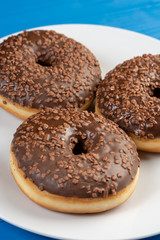 Donut With Chocolate Topping Cream On The Blue Background