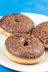 Donut With Chocolate Topping Cream On The Blue Background