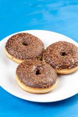 Donut With Chocolate Topping Cream On The Blue Background