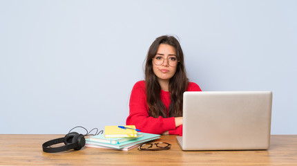 Teenager student girl studying in a table feeling upset