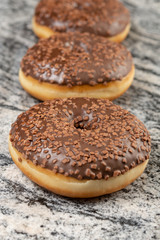 Donut With Chocolate Topping Cream On The Grey Marble