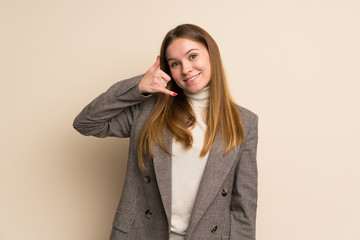 Young business woman making phone gesture. Call me back sign