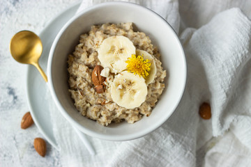 oatmeal porridge with banana and almond, top view