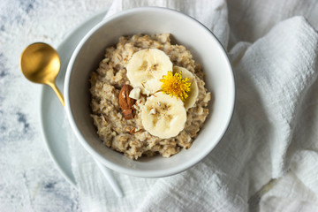 oatmeal porridge with banana and almond, top view