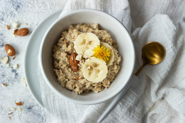 oatmeal porridge with banana and almond, top view
