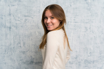 Fototapeta premium Young woman over grunge wall laughing
