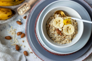 oatmeal porridge with banana and almond, top view
