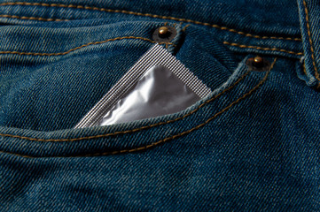 Condom in blue jeans.