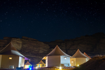 tent under milky way stars in Wadi Rum desert Jordan