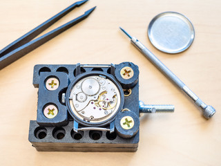 mechanical watch in holder prepared for repairing