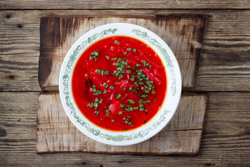Traditional  ukrainian vegetarian beet red soup - borscht on wooden background. Top view.