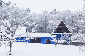 Traditional blue house in the Village Museum during a snowy winter - 263282198