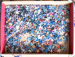 top view of box with disassembled jigsaw puzzle
