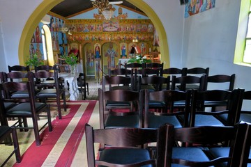 small church inside with icons and chairs in Europe