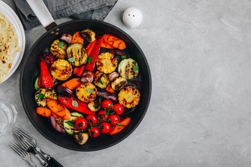 Grilled vegetables in a cast iron pan. Top view.