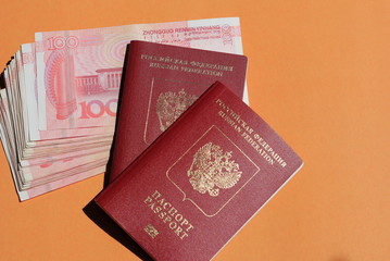 Biometric russian passport and yuan. Tourism, travel and international relations concept.