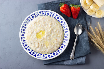 Oatmeal Porridge with Strawberries. Healthy Breakfast with Fresh Organic Berries. Flat lay with copy space.