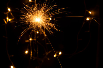 sparkler with blur new year's light close up