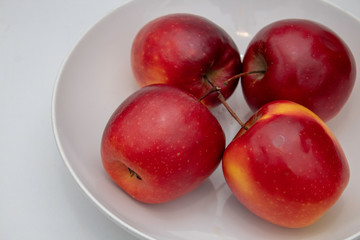 four apples in a bowl