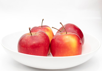 four apples in a bowl