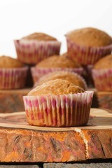 homemade muffins with coconut chips on a wooden stand