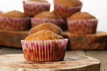 homemade muffins with coconut chips on a wooden stand