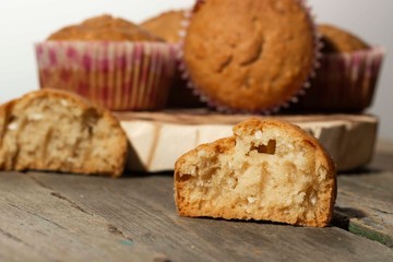 homemade muffins with coconut chips on a wooden stand