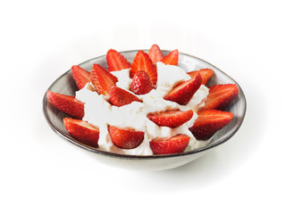 Strawberries with cream in a ceramic bowl with white background