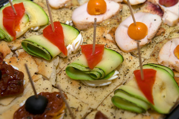 Meat sandwiches with sausage and ham on a plate.