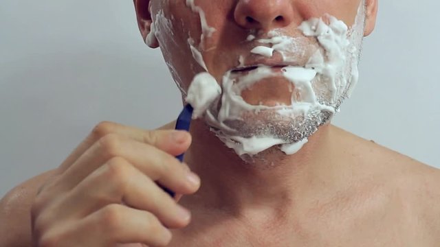 man shaves a cheek-off machine