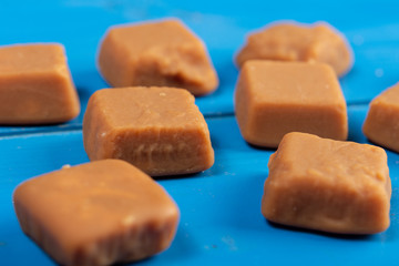 Brown Caramel Candies On The Blue Wooden Boards
