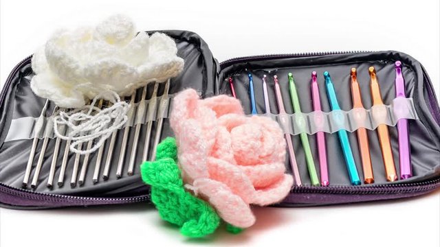 Multi-colored crochet hooks in different sizes in the package. Panning. 4K