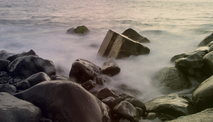 evening fog on the rocky ocean shore