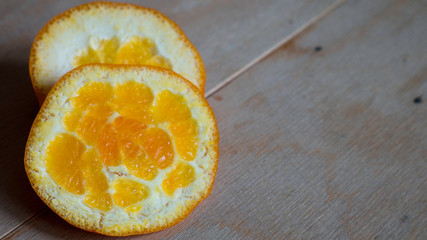 Cut orange peel on a wooden table