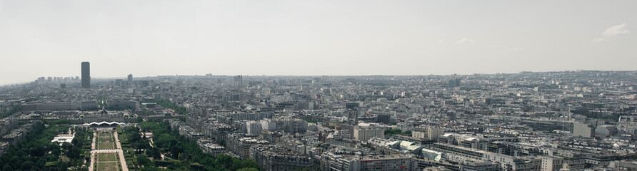 Fototapeta na wymiar A panoramic view of the beautiful city of Paris, France, but a huge portion of the picture is about crowded urban districts that are not an ideal place for living.