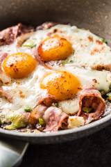 English breakfast fried bacon ham and eggs in ceramic pan