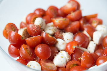  Home cooking. Salad of cherry tomatoes and mozzarella with spices.