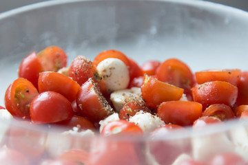  Home cooking. Salad of cherry tomatoes and mozzarella with spices.